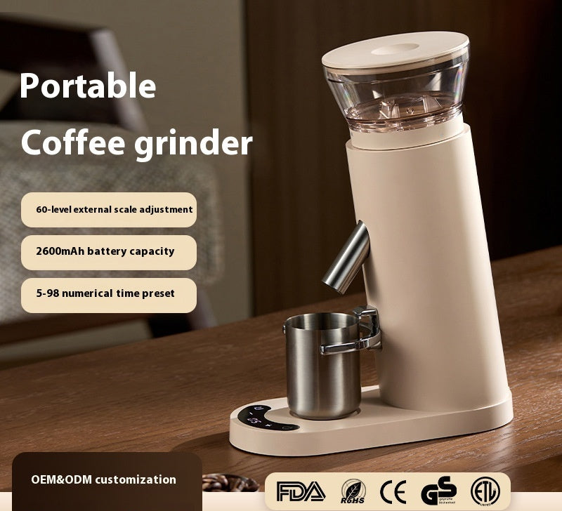 Portable coffee grinder on a wooden surface with text highlighting features and certifications.