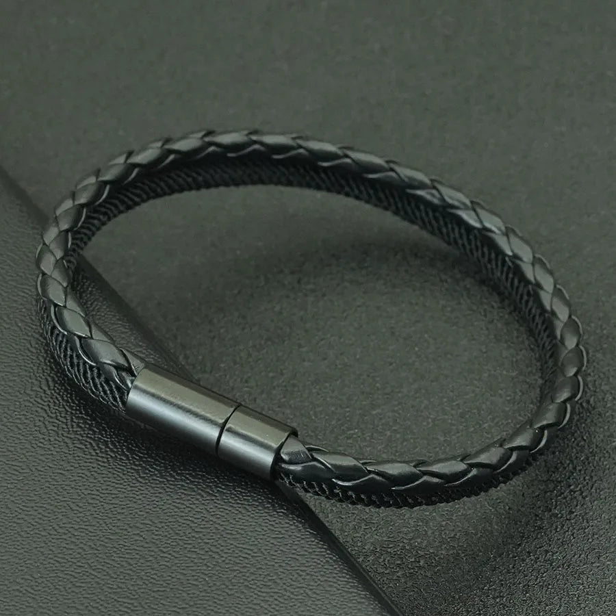 Black braided leather bracelet with a metallic clasp on a dark gray background
