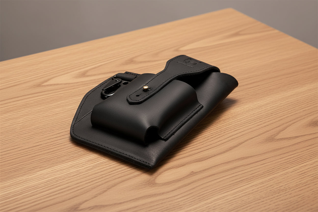 Black leather pouch with strap on a wooden surface, featuring Bullcaptain brand.