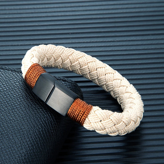 Bracelet with braided design and metal clasp on a textured surface