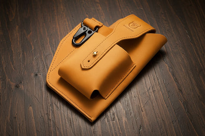 Yellow leather pouch with a black clip on a wooden surface, featuring the Bullcaptain brand.