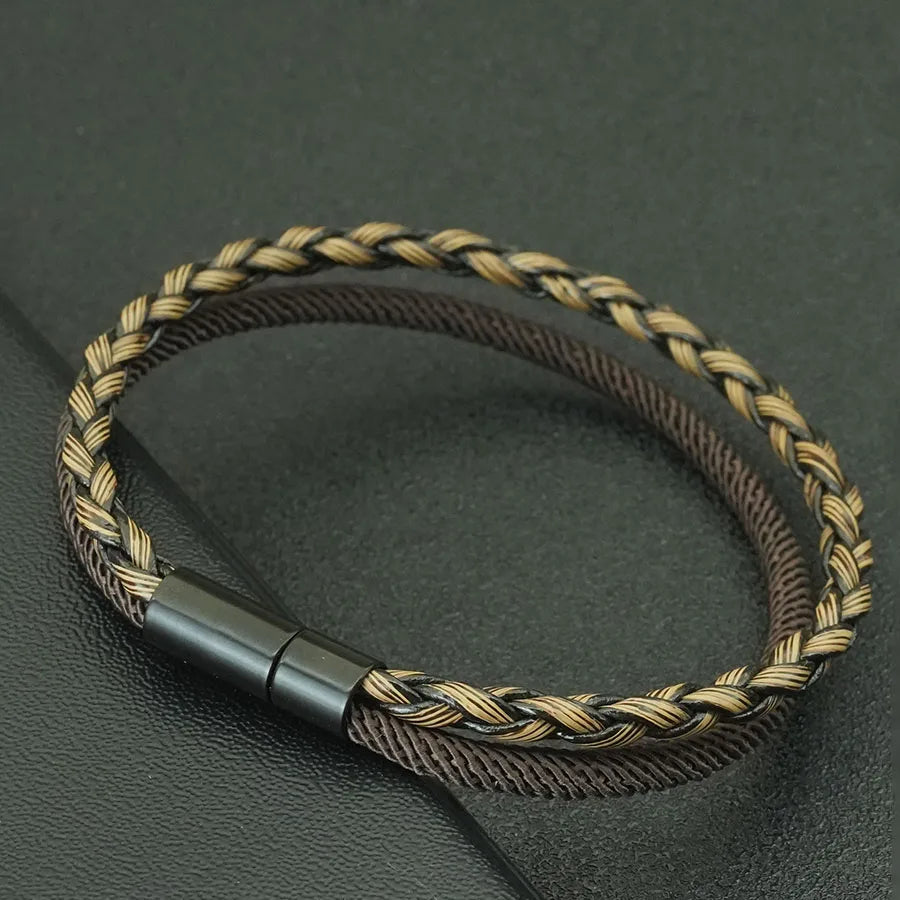 Braided brown and gold bracelet on a dark gray background