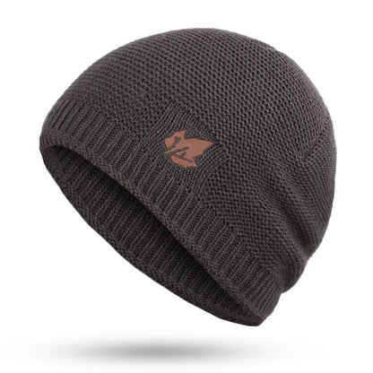 Dark gray knit beanie with a logo on a white background