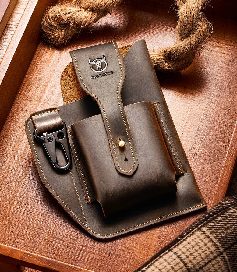Brown leather holster with a gun on a wooden surface