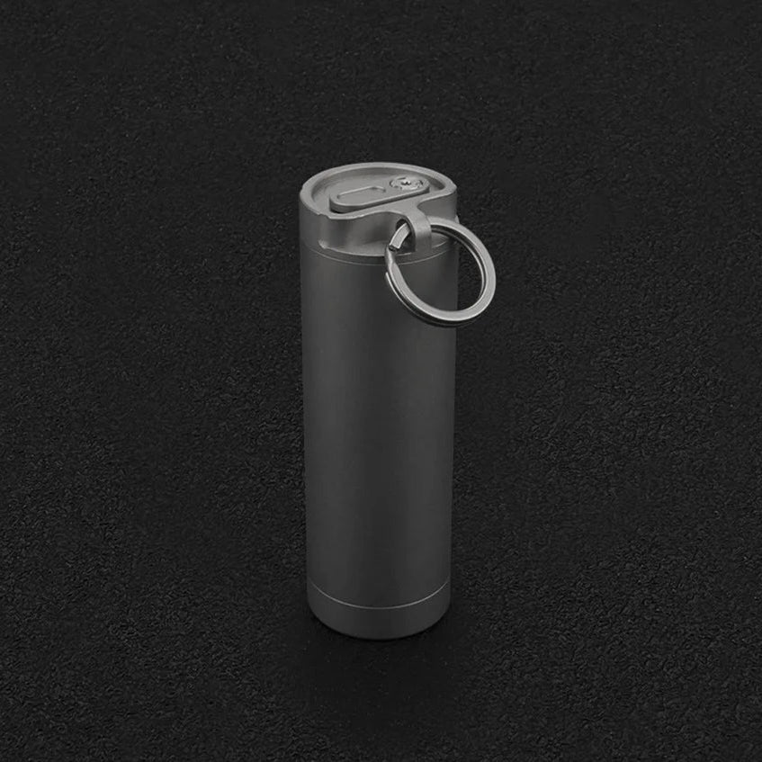 Black cylindrical container with a keyring on a black background, featuring the brand 'Advance'.