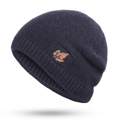 Navy blue knit beanie with a logo on a white background