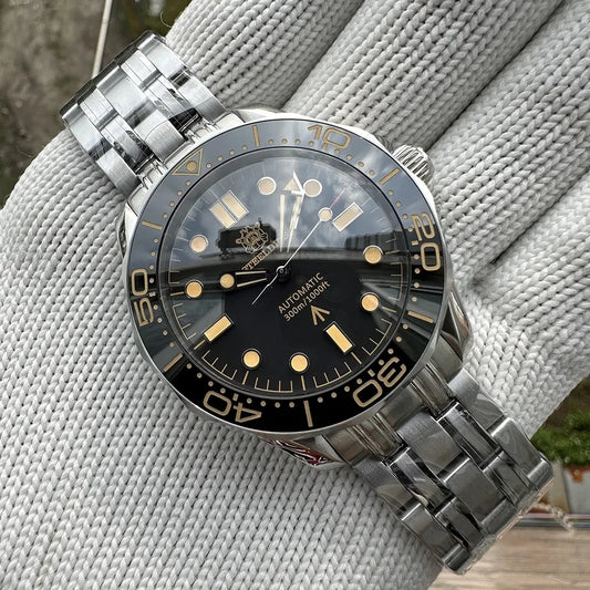 Silver wristwatch with black dial on a textured surface