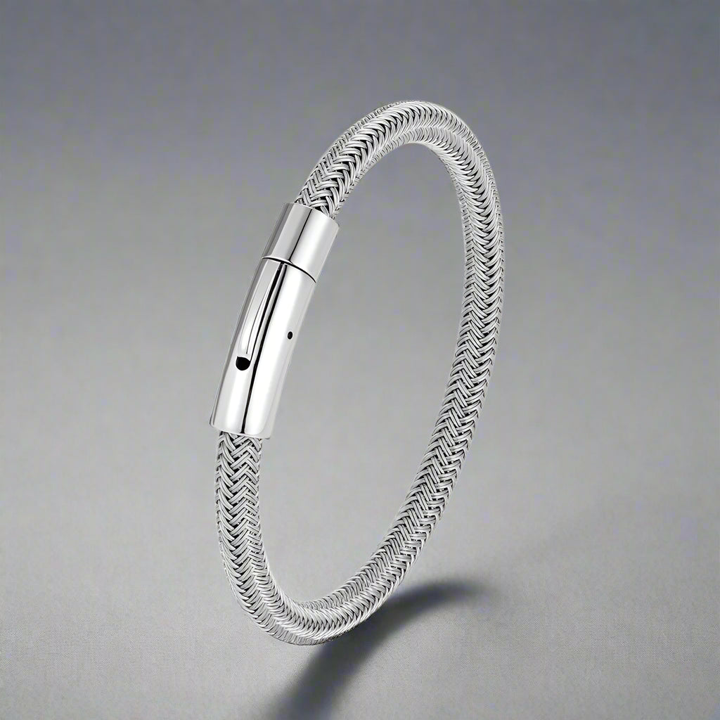 Silver braided bracelet with a metallic clasp on a white background