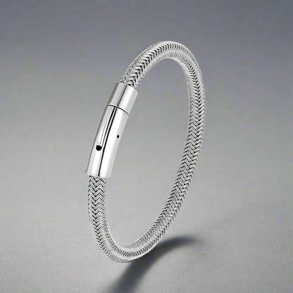 Silver braided bracelet with a metallic clasp on a white background