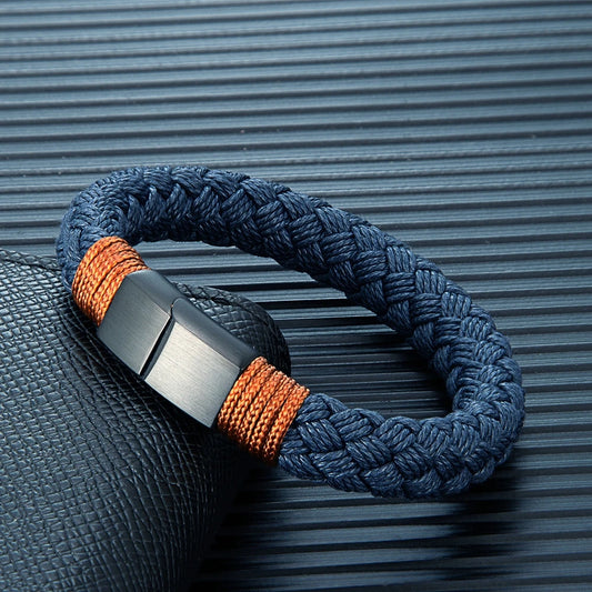 Bracelet with blue and orange braided design on a textured surface